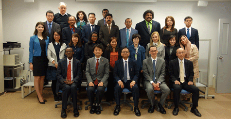 a group of people in suits and ties posing for a photo