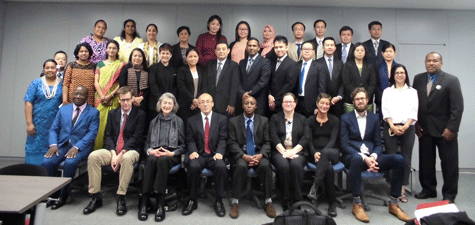 a group of people in suits and ties posing for a photo