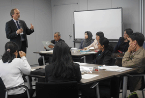 a man giving a presentation to a group of people