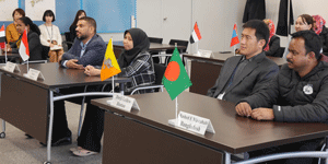 a group of people sitting at tables with flags