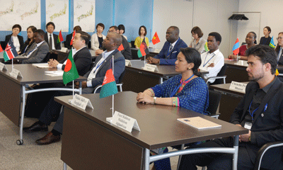 a group of people sitting at tables with flags