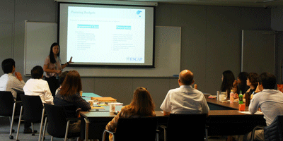 a woman giving a presentation to a group of people